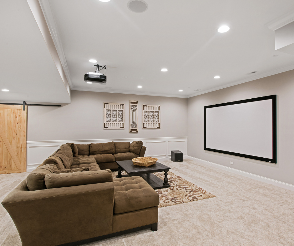 Example of a basement entertainment center with projection screen and large comfortable couch for enjoying movies with the family