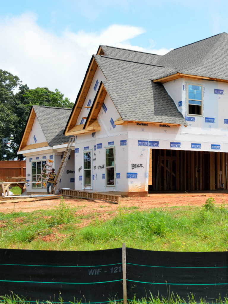 Example of a new home construction project - the walls and roof are complete and waiting for siding.