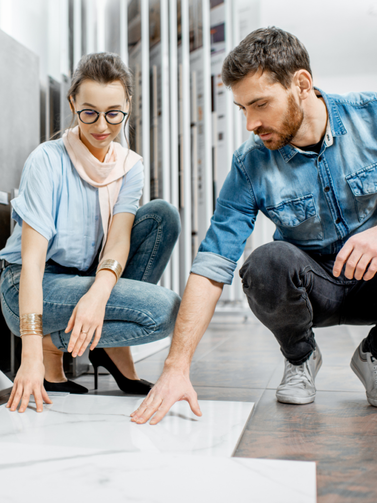 Two people looking at flooring options to demonstrate the process of flooring selection and design