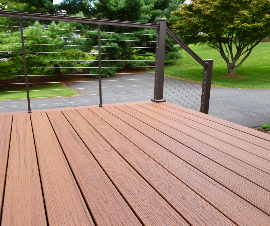 A composite wood deck with modern minimalist metal railing
