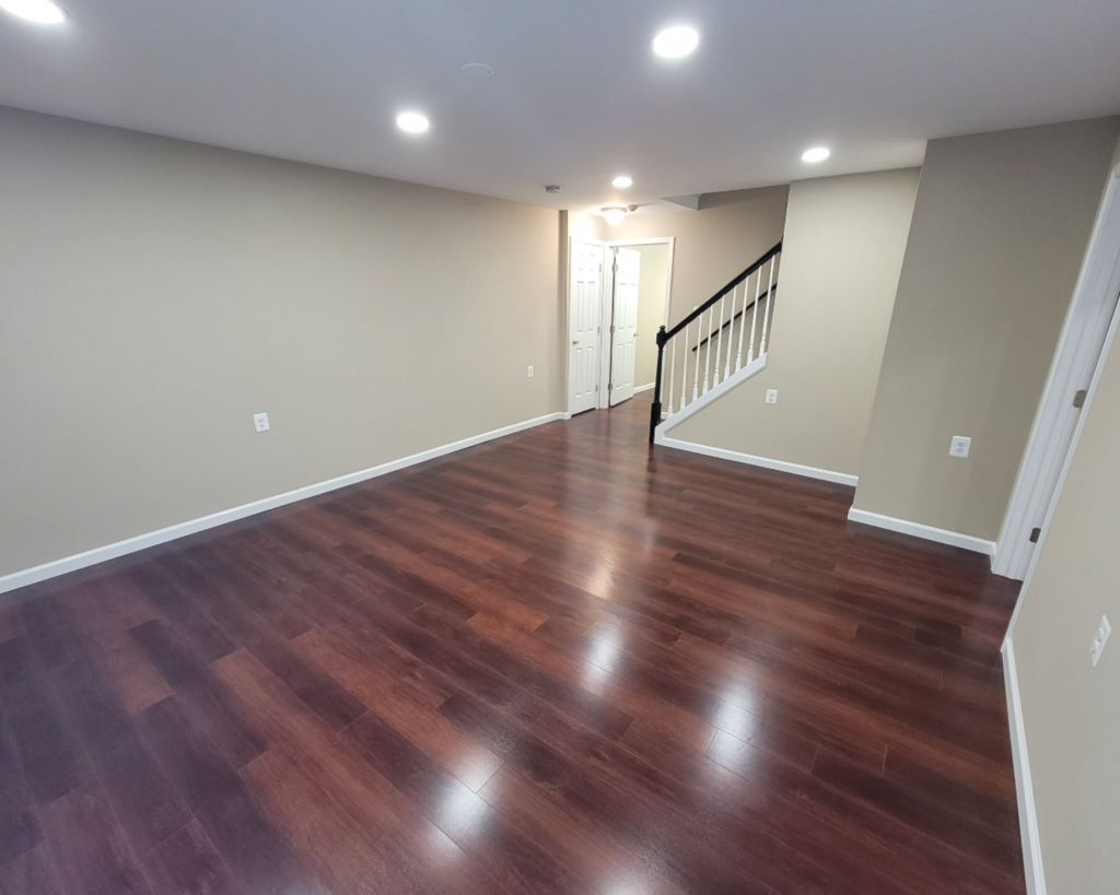 A basement remodeling project with neutral cream walls and natural cherry hardwood flooring that shines!