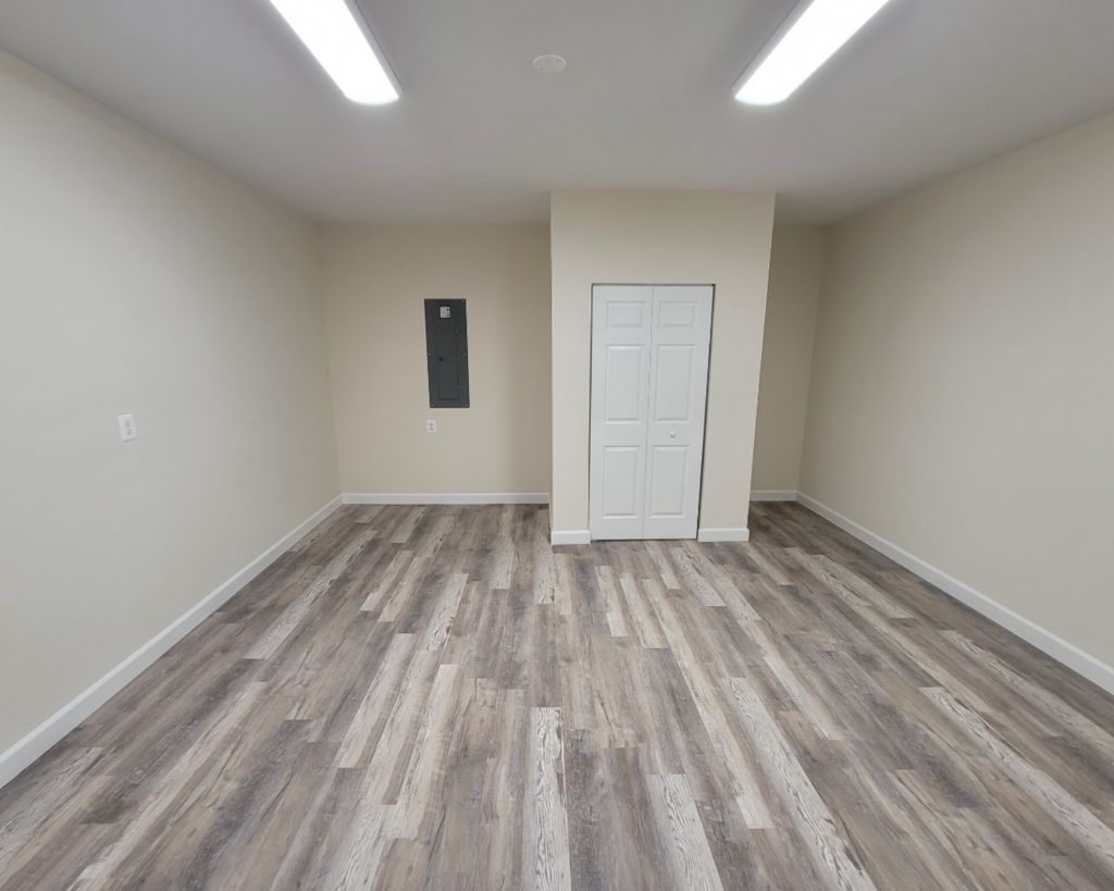 rustic gray laminate wood flooring installed in a basement by the homeowners helper