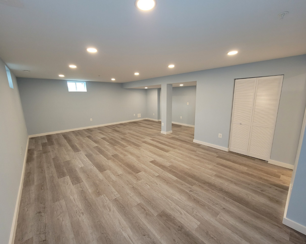 Laminate wood flooring installed by the homeowners helper in a basement