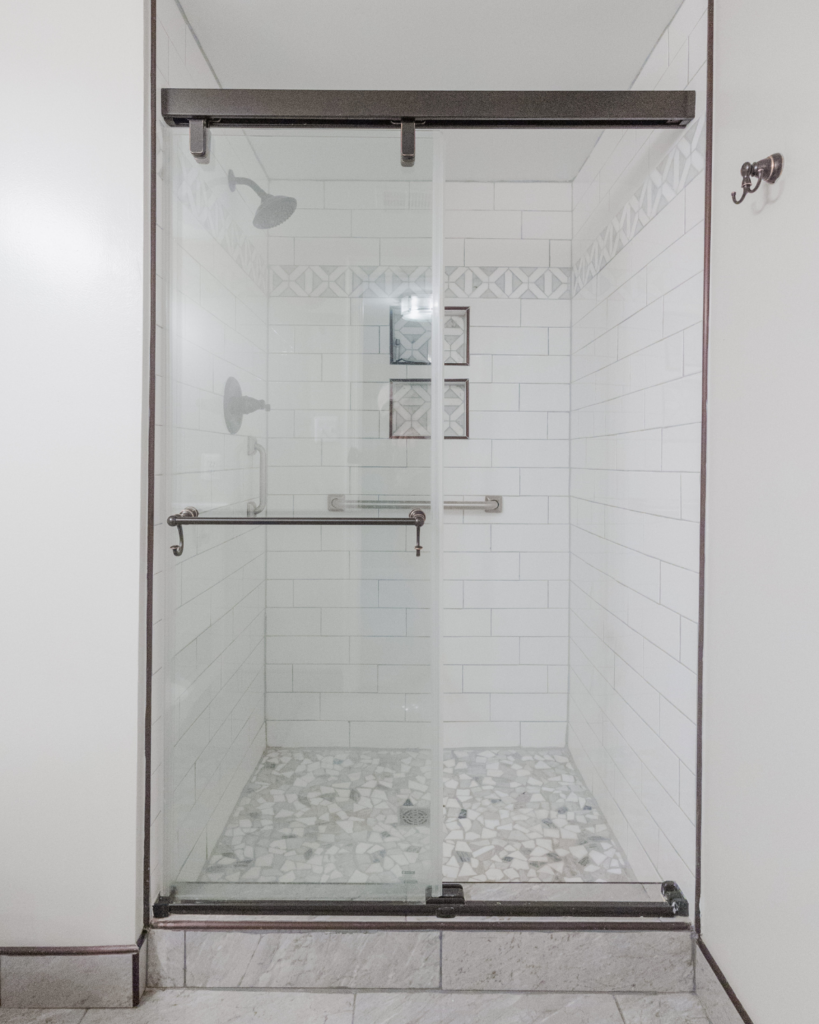 a shower with glass door, tile, and, modern copper fixtures from a bathroom remodel in Frederick md