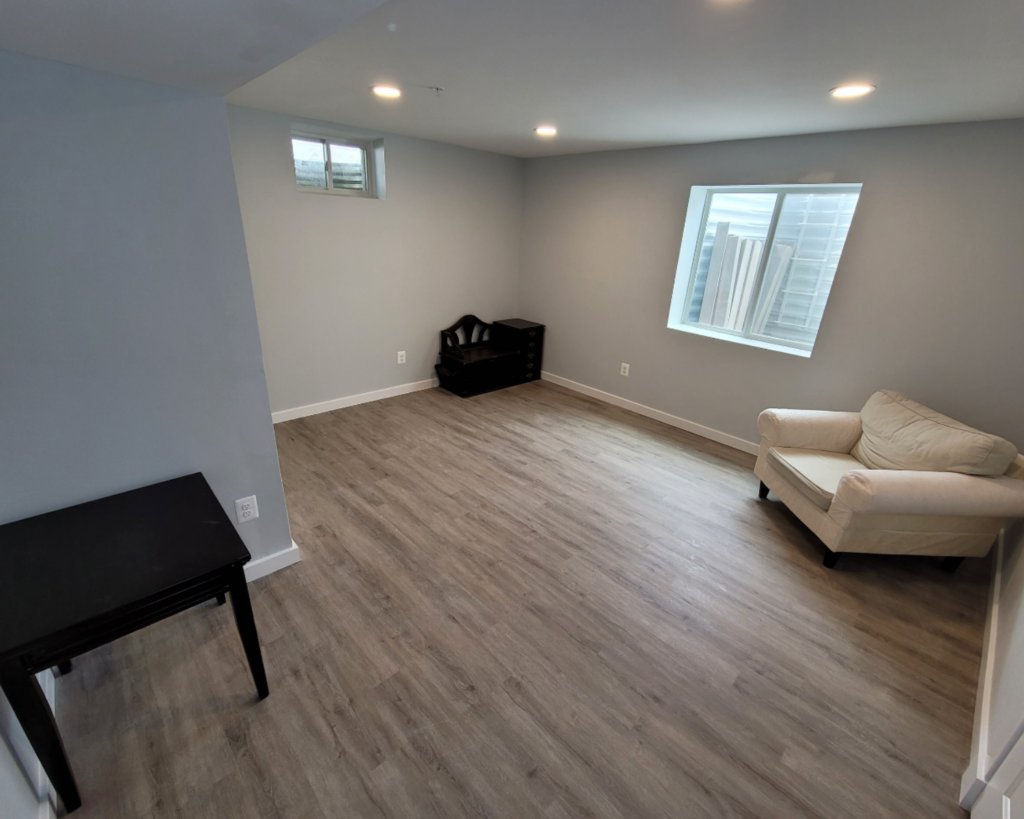 Neutral laminate flooring in a basement remodel project